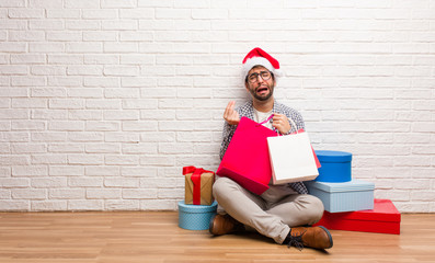 Young crazy man celebrating christmas in his house