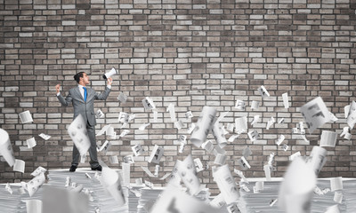 Businessman standing with megaphone.