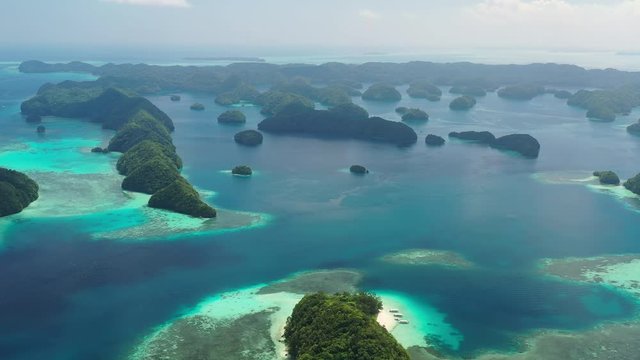 Aerial view of South Rock Islands (Chelbacheb), lush green islets around Mecherchar island, seascape with colorful coral reefs and tropical lagoons - landscape panorama of Micronesia from above, Palau