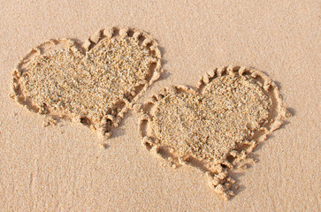 Two heart shapes drawn at the beach