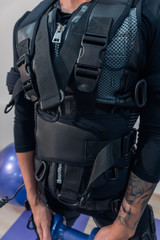 Woman in suit EMS closeup. Fitness. Electromuscular stimulation