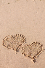 Two heart shapes drawn at the beach
