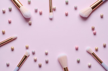 Make-up brushes on a pink pastel background. Flat lay,top view.