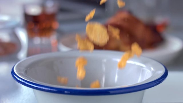 closeup slowmotion cornflakes fallin in bowl