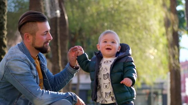 Young father playing with his little son