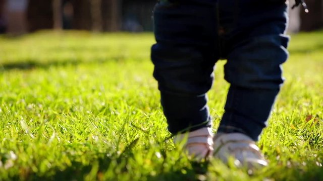 Young father learning his little son to walk