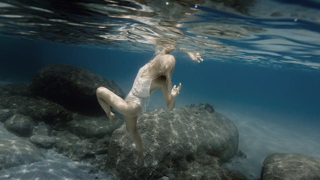 Woman In White Under Water In The Sea