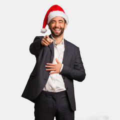 Young business man wearing santa hat dreams of achieving goals and purposes
