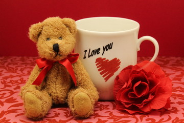 Happy Valentine's Day card with teddy, red rose and mug saying I love you.