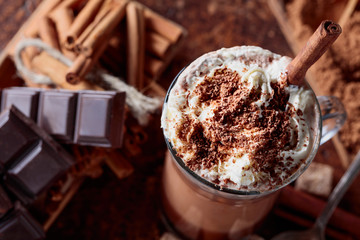 Cocoa with cream, cinnamon, chocolate pieces and various spices.