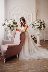 Portrait of beautiful young woman in white wedding dress smiling