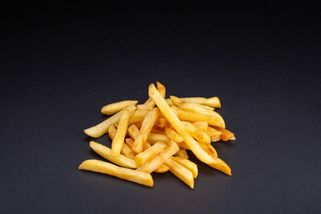 Pile of french fries over black background