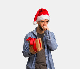 Young man wearing santa hat coughing, sick due a virus or infection