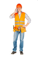 Portrait of a male builder in a helmet  looking at camera over white wall background. repair, construction, building, people and maintenance concept.