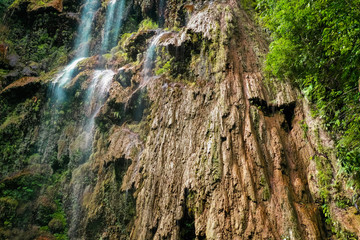 Tumalog waterfall in a mountain gorge in the tropical jungle of the Philippines, Cebu.
