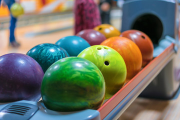Fototapeta na wymiar Colorful Bowling balls on ball return close up