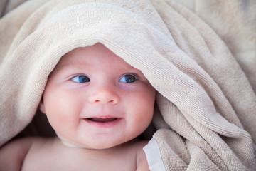 baby girl covered with towel