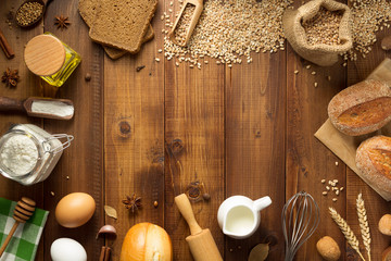 wheat grains and bakery ingredients on wood