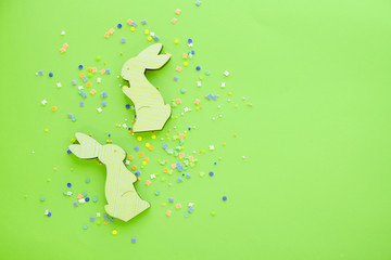colorful background for easter, wooden bunnies and sweets
