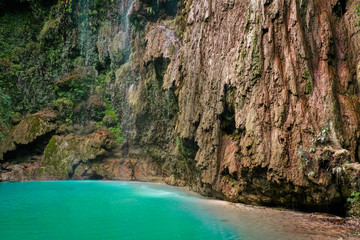 Tumalog waterfall in a mountain gorge in the tropical jungle of the Philippines, Cebu.