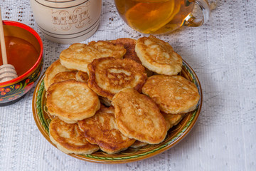 pancakes with honey on the table tea with lemon