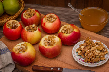 Fototapeta na wymiar sweet ripe apples, walnuts and honey for baking