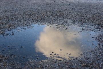Cloud in puddle reflection gravel