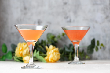 Cocktails in a martini glass on a gray background.
