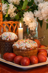 Easter composition with a traditional Russian Easter cake, Easter eggs and flowers on the table