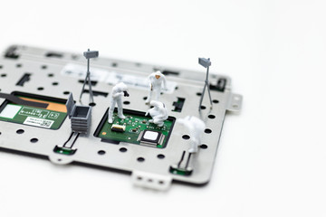 Miniature people: Workers repairing circuit board ,electronics repair. Use image for support and maintenance business.