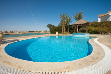 Fototapeta na wymiar Swimming pool at at luxury tropical holiday villa resort