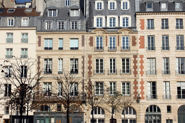 Facade of a traditional apartmemt building in Paris, France