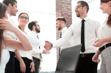 handshake business people in a modern office