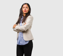 Young business indian woman crossing his arms, serious and imposing, feeling confident and showing power