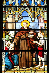 Fototapeta premium Saint Anthony distributes bread, stained glass, Saint Severin church, Paris, France