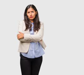 Young business indian woman very angry and upset, very tense, screaming furious, negative and crazy