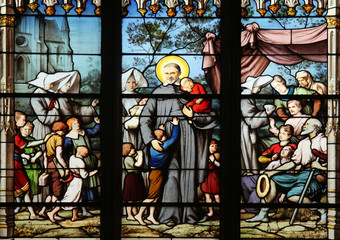 Obraz na płótnie Canvas Saint Vincent de Paul gathering with the Daughters of Charity abandoned children, Pieta, stained glass, Saint Severin church, Paris, France