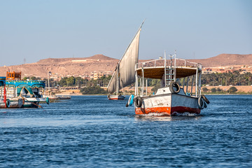 12.11.2018 Aswan, Egypt, Colorful painted boats felucca on the river nil on a sunny day