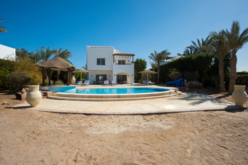 Swimming pool at at luxury tropical holiday villa resort