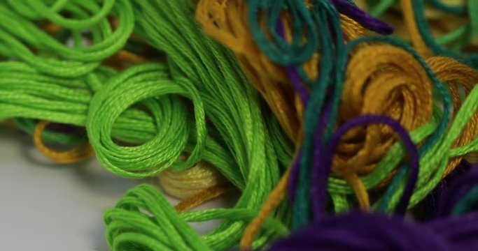 Rows spools of thread of different colors in the industrial sewing machine