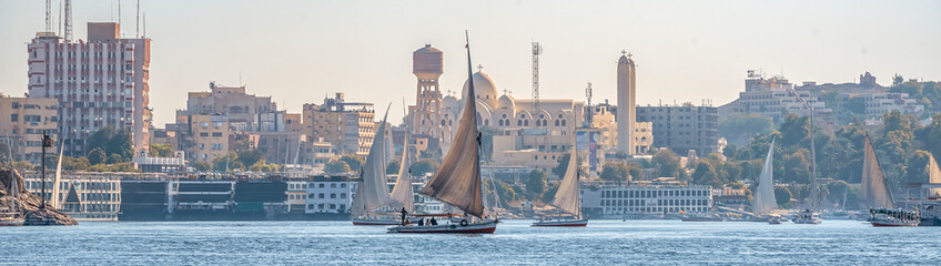 12.11.2018 Aswan, Egypt, A boat felucca sailing along a river of nilies on a sunny day against a...