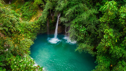 Naklejka na ściany i meble Kawasan waterfall in a mountain gorge in the tropical jungle of the Philippines, Cebu.