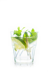 Lime and mint drink glass isolated on white background. Selective focus.