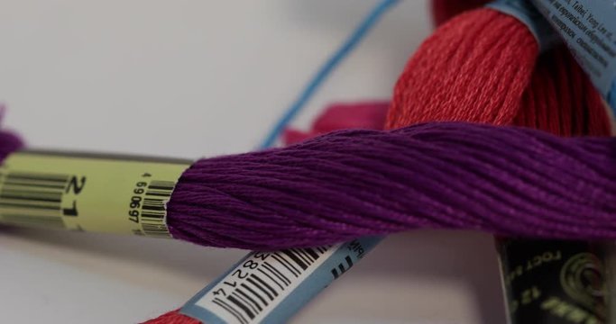 Rows spools of thread of different colors in the industrial sewing machine