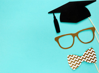 Creative background with photobooth props for graduation: hats, diploma, glasses, lips on bright...