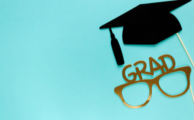 Creative background with photobooth props for graduation: hats, diploma, glasses, lips on bright...