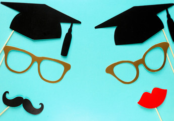 Creative background with photobooth props for graduation: hats, diploma, glasses, lips on bright...