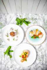 delicious dinner of salmon steak, grilled beef medallions and chicken fillet with vegetables