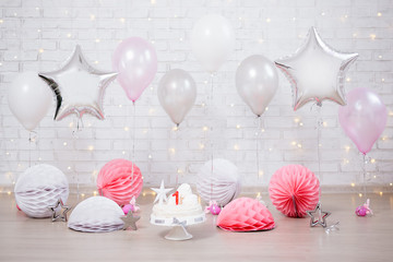 first birthday background - decorated room with cake and balloons over white wall