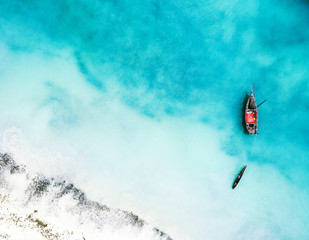 boat and ship in beautiful turquoise ocean near an island, top view, aerial photo - obrazy, fototapety, plakaty
